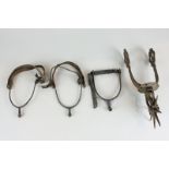 A pair of 19th century spurs with leather straps (a/f), another similar and a larger metal spur (4),