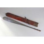 An African bladed weapon in leather sheath, paddle shaped with slender handle, blade 50cm long