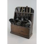 An oak cutlery wall box containing pewter serving spoons, various forks, knives, etc (a/f), 47cm