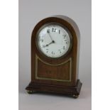 An Edwardian mahogany cased mantel clock with eight day movement and circular white enamel dial,