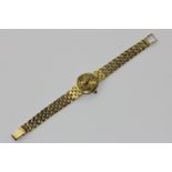 An 18ct gold Baume bracelet watch retailed by Garrard