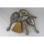 A pair of Victorian silver backed hair brushes, together with a silver hand mirror and matching