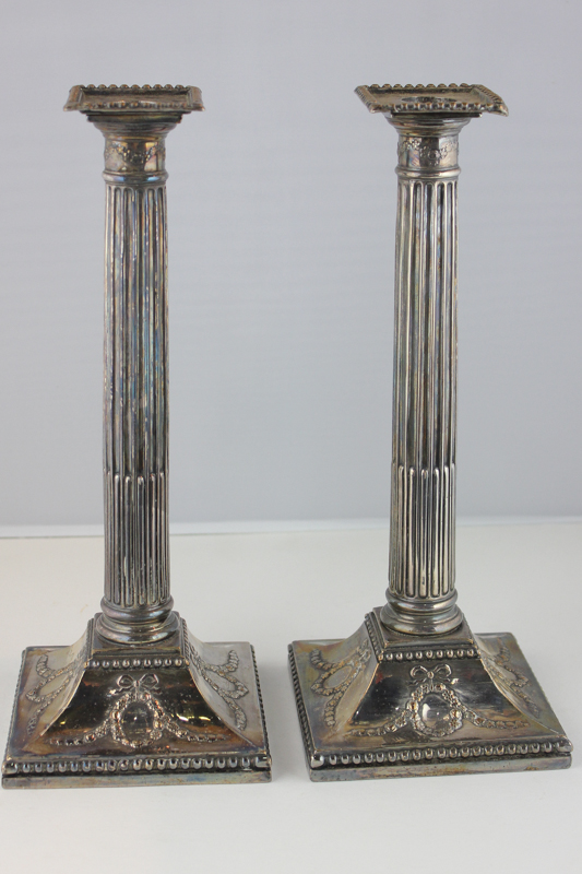 A pair of silver plated Corinthian column candlesticks with floral swag and bow decoration, 28.5cm