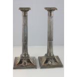 A pair of silver plated Corinthian column candlesticks with floral swag and bow decoration, 28.5cm