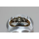 A diamond three stone ring claw set with graduated old cuts in silver cut down collets