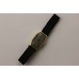 A lady's Swiss 18ct gold wrist watch, octagonal case, unsigned dial and movement, on ribbon strap,