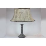 A Chinese bronzed metal table lamp with column support, flared base and all over decoration, 41cm