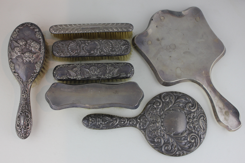 Five various silver dressing table brushes and two silver backed hand mirrors