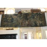 A large 19th century tapestry depicting a figure in a wood, 400cm by 300cm approx. (NC)