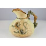 A Royal Worcester jug decorated with a lizard on a basket weave body, with a stylized rope and