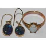 An opal ring four claw set with an oval cut stone in 14ct gold; a pair of opal drop earrings in 14ct