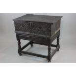 A 17th century oak lace box with carved front, 67cm, on later oak stand (NC)