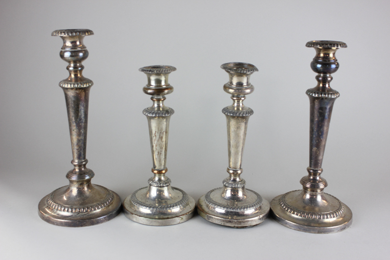 Two pairs of silver plated candlesticks with gadroon borders and plain tapered stems, 29cm and