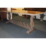 A 19th century Continental refectory table on twin cherub supports joined by stretcher rails,