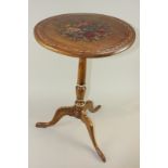 A 19th century mahogany circular table with later floral painted tilting circular top, on turned