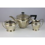 A George VI silver three piece tea set maker G Mills and Co Birmingham 1946, with circular bodies,