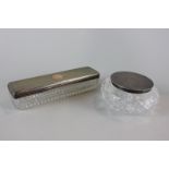 A silver lidded rectangular glass dressing table box, 18cm, and a silver lidded circular glass