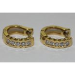 David Morris, a pair of 18ct yellow gold and diamond loop earrings, each set with five brilliant