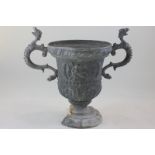 A lead two-handled garden urn, cast with a figure on horseback and acanthus leaves (base with part