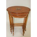 A nest of three 'Sheraton Revival' satinwood occasional tables with painted decorated tops of oval