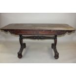 A William IV rosewood library table with two frieze drawers on twin carved trestle and flat base,