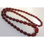 An cherry amber bead necklace graduated ovoid beads with screw clasp, 111.7g