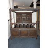 An 18th century and later oak four poster bed with carved panelled headboard and anno 1796 Tricken