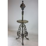 A Victorian ornate cast brass oil lamp/table with adjustable column and onyx table top on scroll and