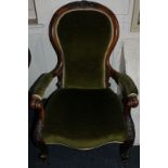 A Victorian open arm chair with spoon shaped back and scroll arms, with serpentine seat