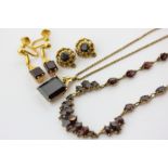 A 9ct gold and garnet necklace, a pair of garnet and 9ct gold ear clips. a 14ct gold pendant and