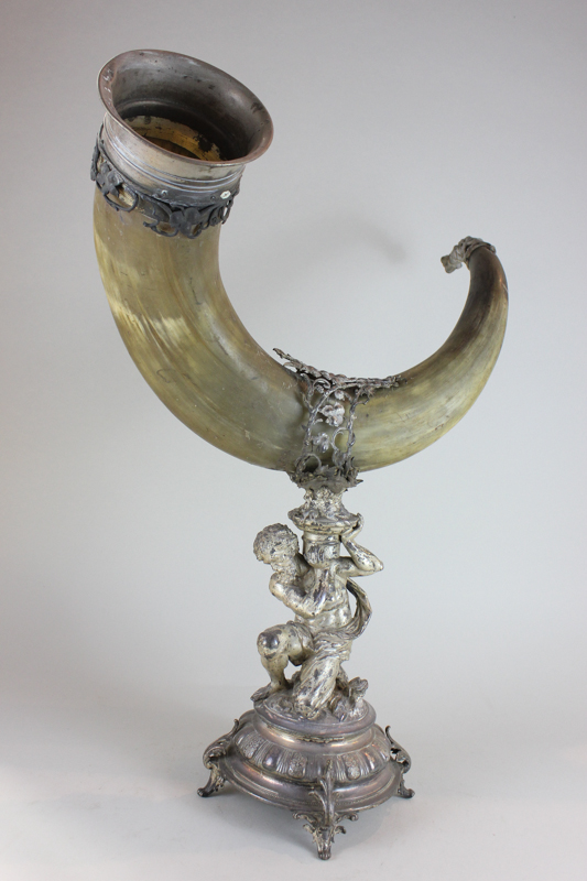 A Victorian plated centrepiece modelled as Atlas kneeling holding a large plated cow horn on his