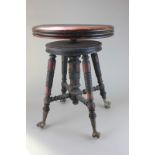 A stained wood piano stool with circular adjustable seat on turned legs and brass feet, with glass