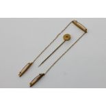 Three 14ct gold and seed pearl chained brooches and an amethyst stick pin