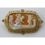 A shell cameo brooch carved with playful putti in a gold filigree mount with safety chain