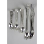 A pair of George III silver sugar tongs, London 1812, another similar pair (marks worn), a smaller