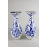 A pair of Japanese porcelain vases with floral rims, both repaired, 39cm