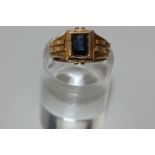 A sapphire single stone ring, the oval cut stone in a rectangular setting