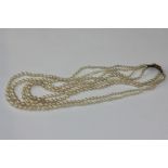 A four row cultured pearl necklace on gilt metal clasp (NC)