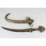 A North African jambiya dagger with gilt metal mounted handle, 29cm carved blade and scabbard, 45cm,