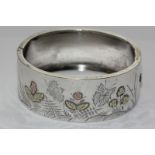 A silver and two colour gold overlaid bangle