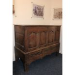 An early 18th century oak mule chest, later adapted with sliding four panel front, on base with four