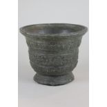 A bronze mortar, cast with banded decoration of scrolls and leaves, 13cm high, (NC)