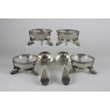 Four silver plated Georgian style salts with gadroon borders and open sides on three legs shaped