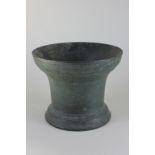 A bronze mortar with flared rim and circular base, 16.5cm high, (NC)