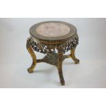 A 19th century Chinese carved hardwood jardiniere stand with inset circular marble top, on four