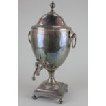 A George III silver plated samovar with ring handles and plain body on square base on ball feet,