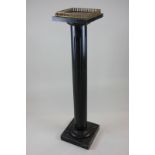 A Victorian ebonised jardiniere stand with fluted column support and gilt metal gallery, 107cm high,