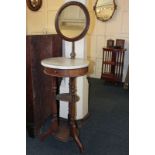 A Victorian marble toped shaving stand with circular mirror, on three turned supports, 150cm high (