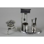 Two Chinese silver pepper pots, one in the shape of a well and the other as a pagoda on stand,