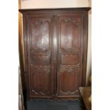 A 19th century French oak armoire with two panelled shaped doors (af - wormed) 154cm (NC)